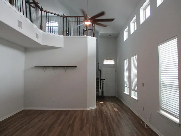 Living area, plank flooring, large ceiling fan
