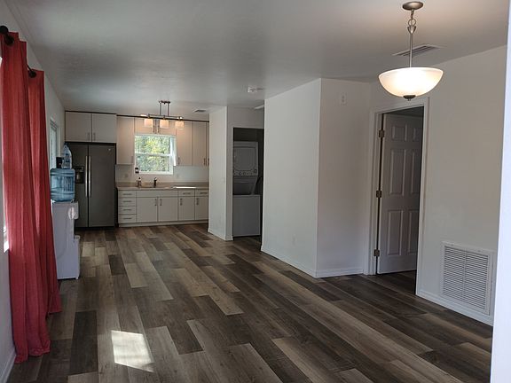 Photo from from is from the front door, facing dining room and kitchen, sliding glass door on the left in dining room area.