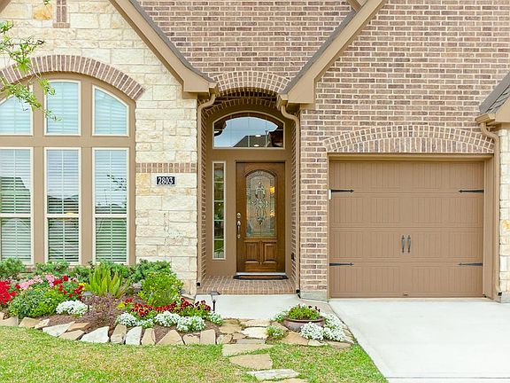 Lush landscape, full sprinkler system and lovely flagstone walkway greet you walking to the front door.
