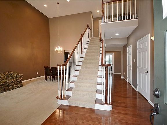 Warm and welcoming foyer with grand staircase