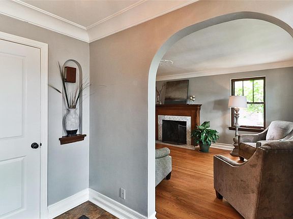 Entry foyer with guest closet and archways leading to living room and dining room (currently used as an office)