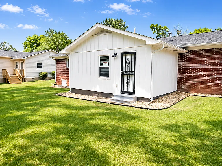 Large backyard with a built-in BBQ grill, ideal for entertaining guests or enjoying outdoor relaxation.