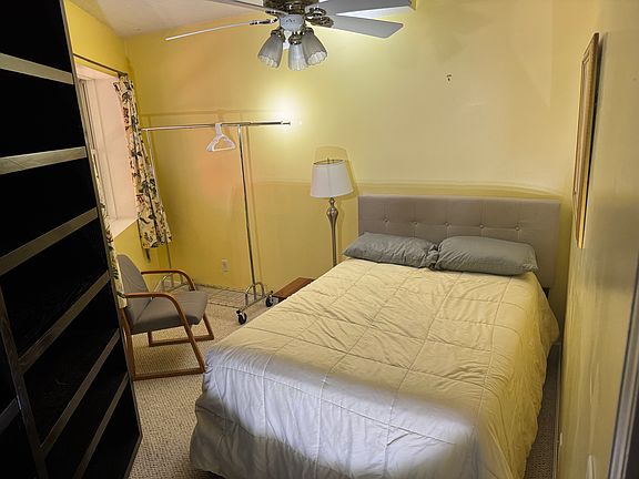 The smaller bedroom has a twin mattress, comfy chair, hang up area and a great deal of shelving