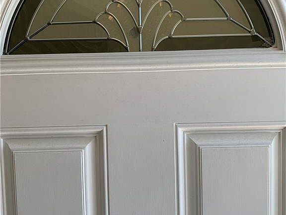 Charming front door adds light in the entry.