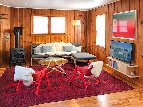 Living room with handmade Persian rug, gas stove, 4K Apple TV + HomePod.