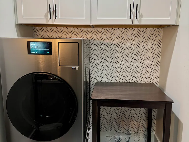 Laundry room in 2nd bathroom. New Samsung heat pump washer & dryer combo unit.