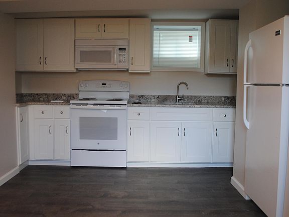 Brand new kitchen featuring a stove/oven, microwave, dishwasher and fridge
