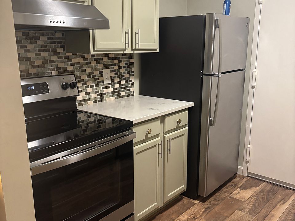Kitchen with stainless steel appliances - oven, refrigerator & dishwasher