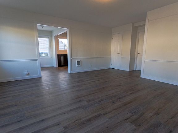 View from the entryway. The kitchen and breakfast nook is on the left, it's a bright room with big windows. The two doors on the right are a linen closet and a small storage room/laundry room. The bedrooms and bathroom are to the right down a hallway.
