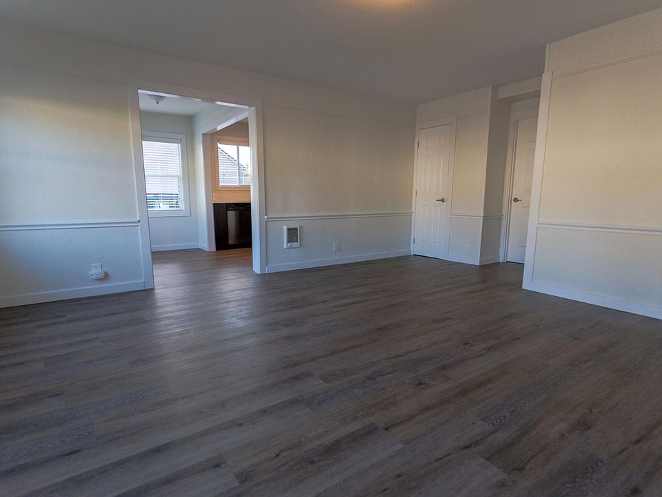 View from the entryway. The kitchen and breakfast nook is on the left, it's a bright room with big windows. The two doors on the right are a linen closet and a small storage room/laundry room. The bedrooms and bathroom are to the right down a hallway.