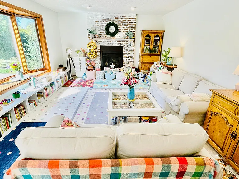 Main Living with Gas Fireplace and Bay Window. Wonderful place to cuddle around for a peaceful winter night reading.