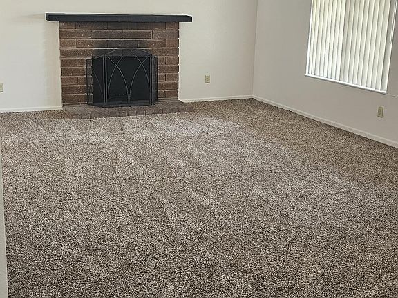 Living Room with Brick Woodburning Fireplace