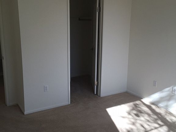 The second bedroom is outfitted with a spacious walk in clos