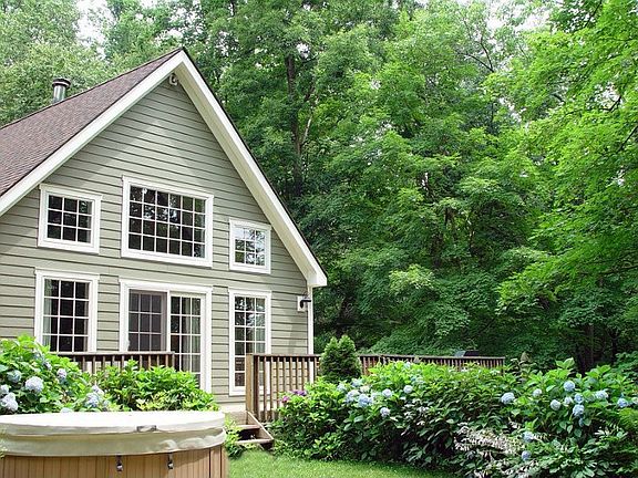 View from the fenced side yard with hot tub and fire pit.