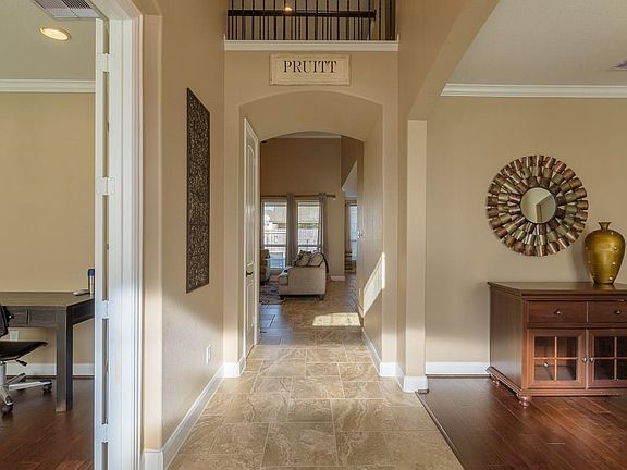 Enter the home on large tile flooring and high ceilings. Arched entries on either side give the entry a spacious feel