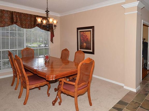 Formal dining room with crown molding...