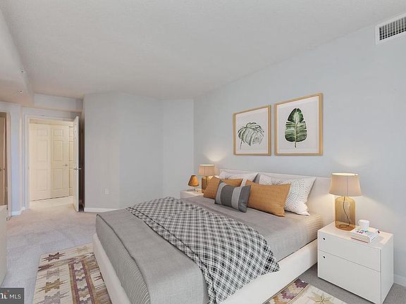 Primary bedroom walk in closet and dual entry bath