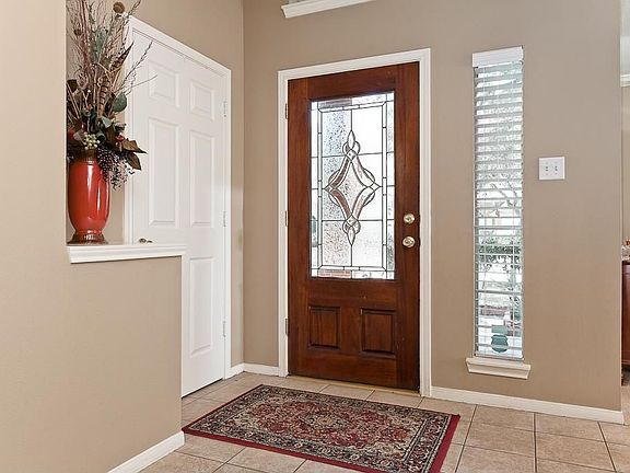 Entry has a leaded glass door and an art ledge.