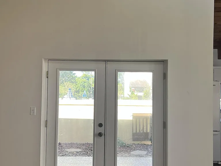 backdoor view, patio entrance and view of the pool. Privacy wall.