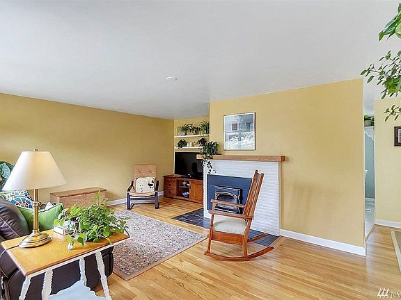 Living room with wood burning fireplace.