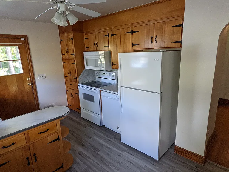 Full kitchen with range, microwave, refrigerator and garbage disposal. Room for table and chairs.