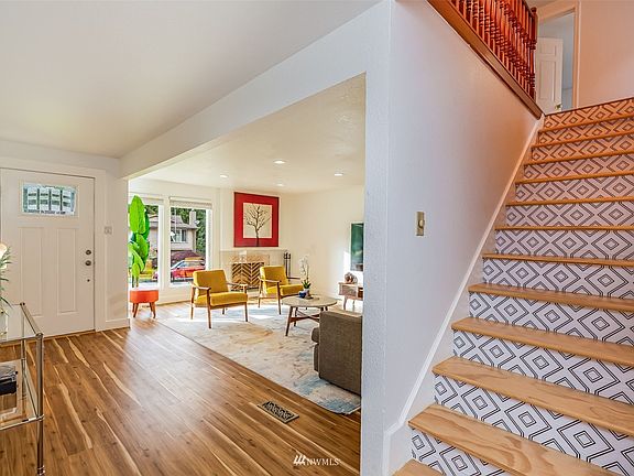 Hardwood stairs lead to upper level
