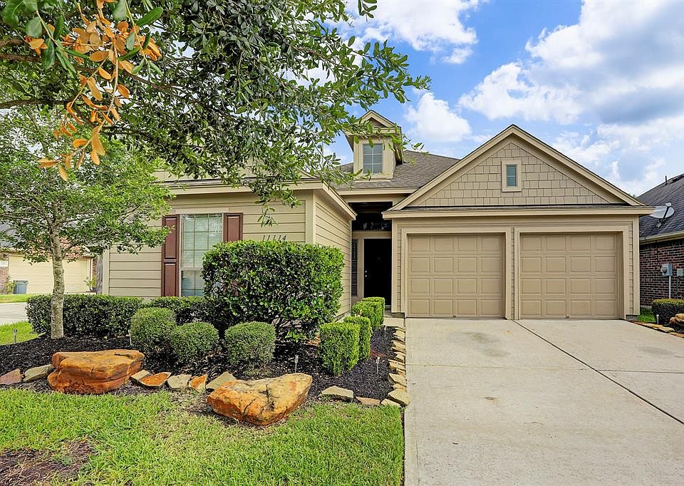 Beautifully maintained exterior with double-wide driveway and attached garage.