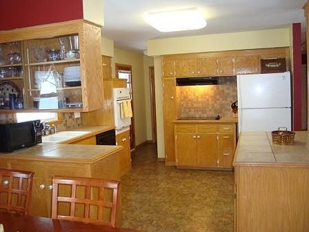 Renovated kitchen that opens up into the living and dining rooms to make a great room living space.