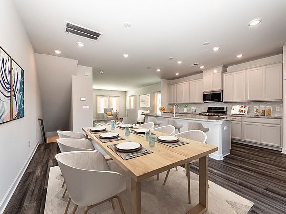 The well-appointed kitchen is fitted with large island overlooking the dining space.