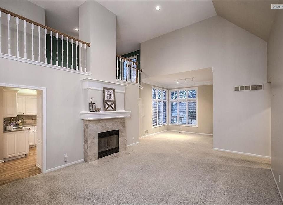 The Great Room is very spacious and is the heart of the home with a soaring ceiling, a loft above and a dining area to the back.