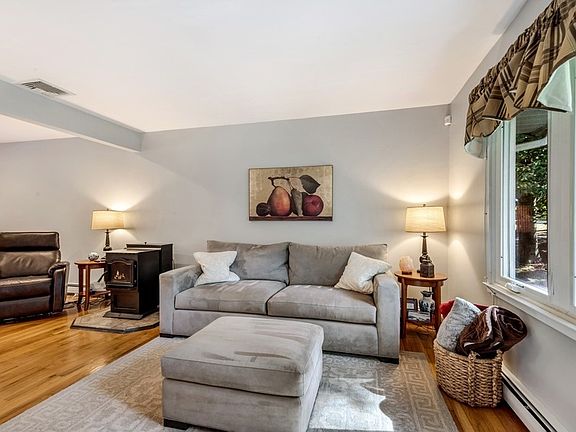 Sunlit living room featuring pellet stove.