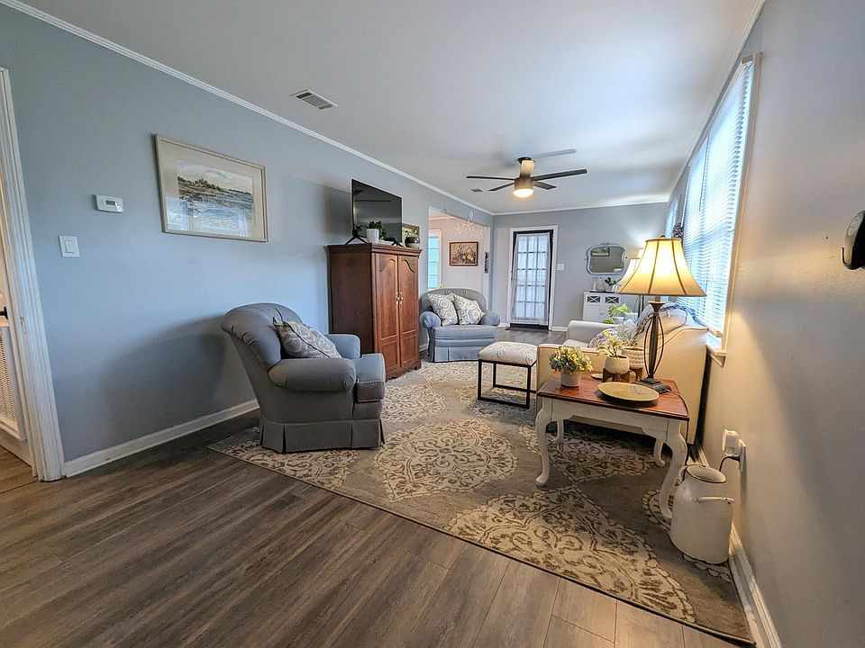 The living room is warm and inviting with plenty of places to sit and watch the smart TV.