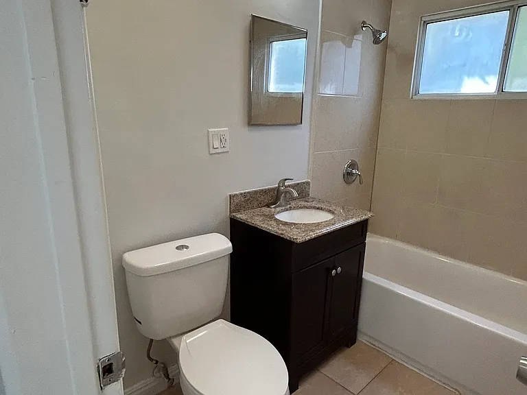 Bathroom, wooden and granite vanity sink, medicine cabinet, curved shower rod, new faucets and shower head