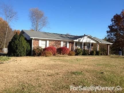 Brick home and shop facing Hwy 118.