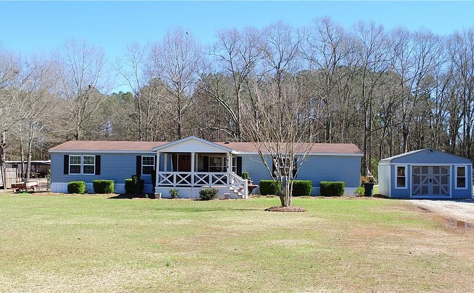 Front of home with workshop to the right. Welcoming covered front porch.