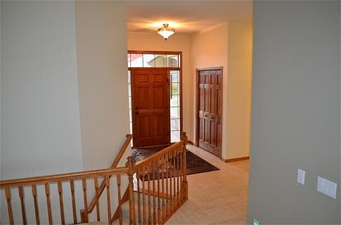 Grand foyer with high ceilings. Plenty of room for greeting guests and shedding the outwear. The fro