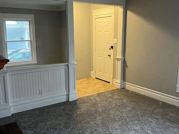 Looking at the front door / mud room from the living room. The mud room includes a nice size coat closet to the left.