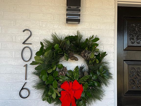 Front porch accented by new automatic "Dawn to Dusk" efficient LED lighting and modern address numbers.
