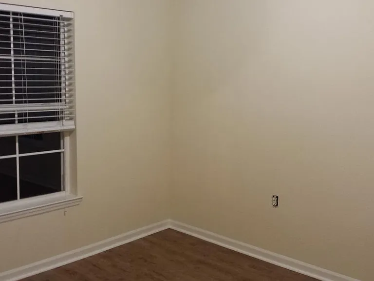 End bedroom on top of garage with two windows