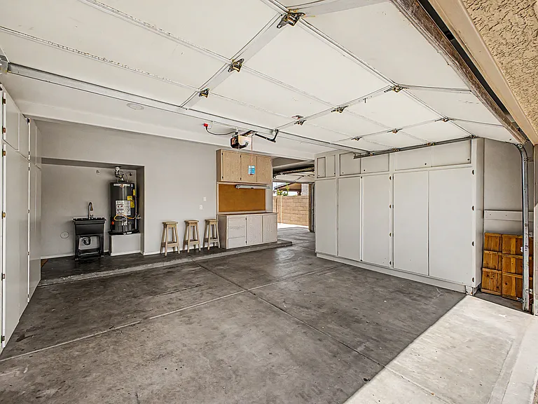 2-Car Garage with ample storage, sink and workbench