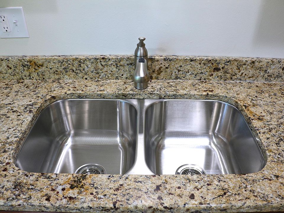 Stainless sink with granite countertops.