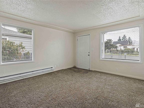 Front living area has nice big windows, newer paint and carpet.
