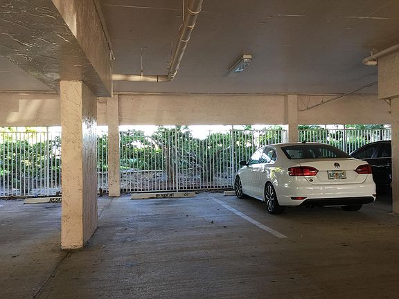 Designated covered parking space steps to lobby and availabl