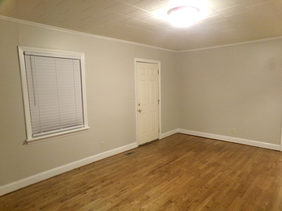 View of Living Room and entry door from opposite wall.