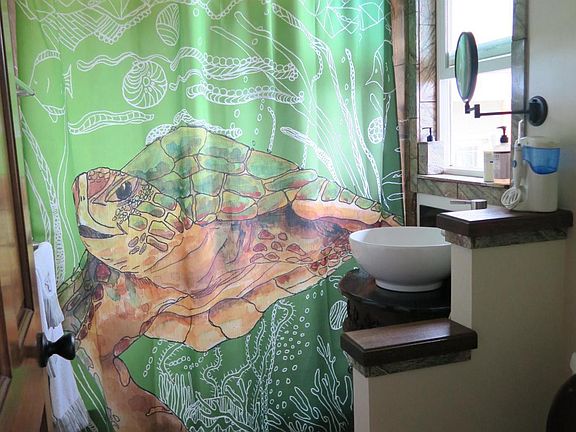 Main bathroom downstairs, tub shower, sink, toilet