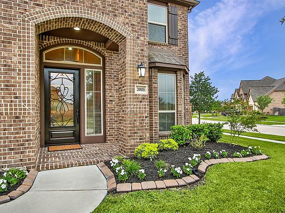 Front porch with rich mahogany 8' door. The home faces North.