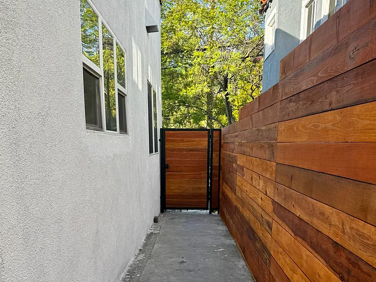 The side entrance and walkway, another private space just for this side of the duplex that wraps around to the back patio area