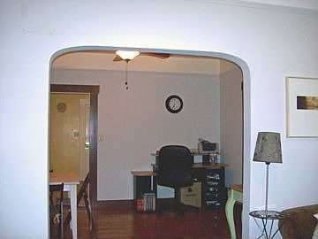Curved arch leads to dining room