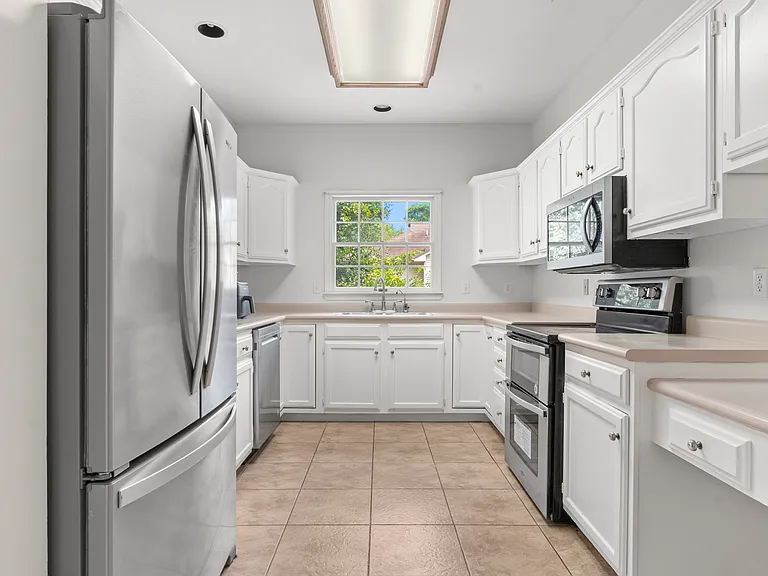 UNDER RENOVATION. to update to Quarts Countertop. - Bright, fully equipped kitchen with generous cabinet space, stainless steel appliances, countertop essentials, and a separate pantry for additional storage.