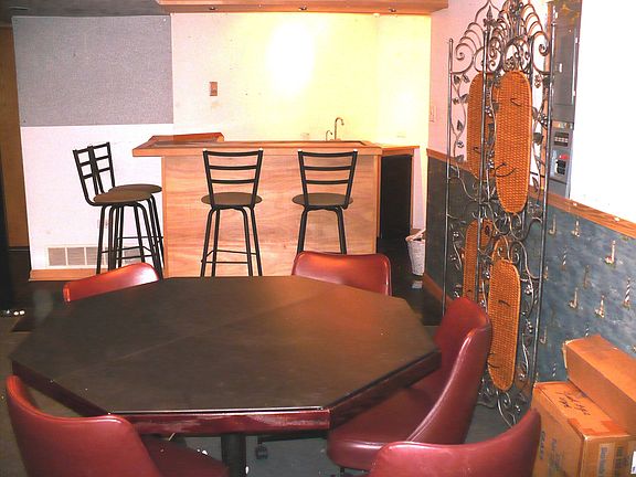 Finished basement with bar and media area 